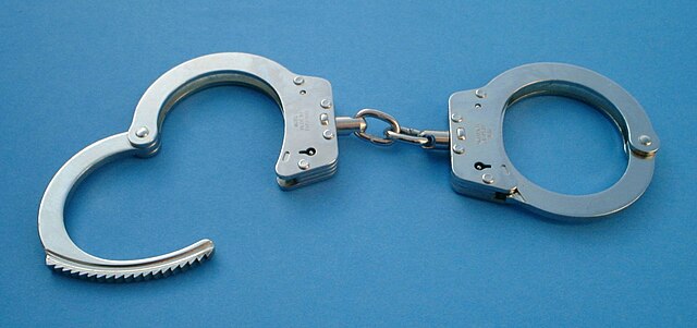 Metal handcuffs with one shackle open
